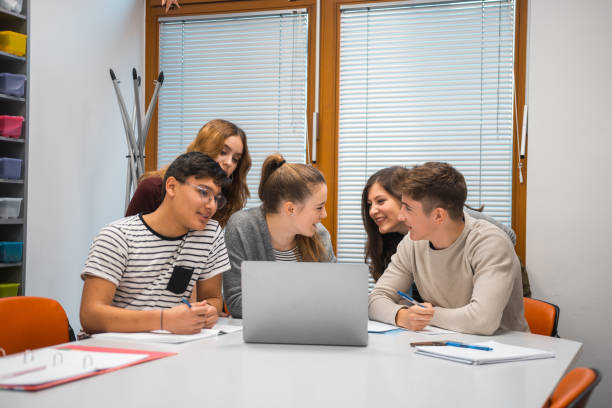 istock Group of students using laptop in the classroom 1197080507