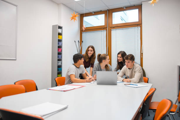 istock Group of students using laptop in the classroom 1197080527