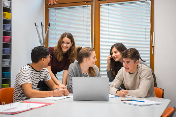 istock Group of students using laptop in the classroom 1197080540