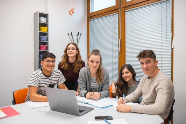 istock Group of students using laptop in the classroom 1197080543