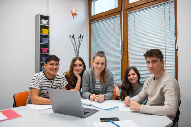 istock Group of students using laptop in the classroom 1197080549