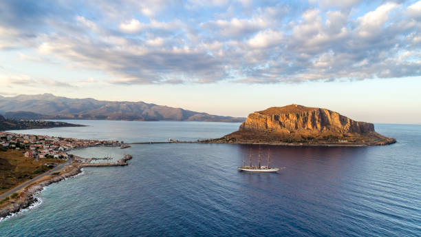 Monemvasia, small rocky peninsula next to Peloponnese with small settlement, located in Greece. View from the town Gefira before sunset, with soft sunlight