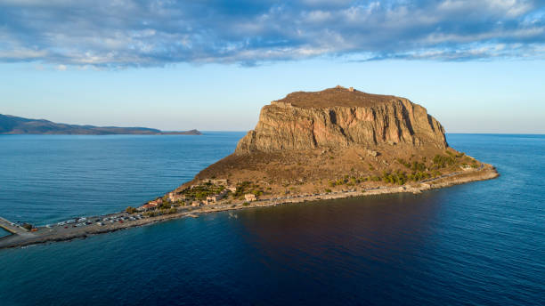 Monemvasia on Peloponnese, Greece Monemvasia, small rocky peninsula next to Peloponnese with small settlement in Greece. Aerial view made with drone before sunset, with soft sunlight monemvasia stock pictures, royalty-free photos & images