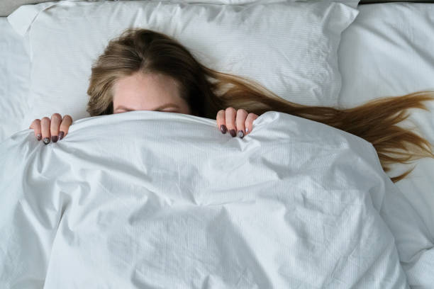 istock Young beautiful woman lying on pillow in bed, top view 1197080792