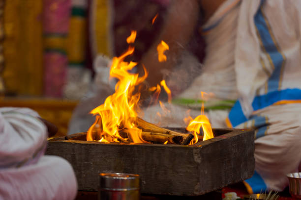 Burning fireplace during a Hindu baptism ceremony Burning fireplace during a Hindu baptism ceremony chennai photos stock pictures, royalty-free photos & images