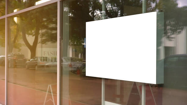 empty white poster frame on glass of showcase empty white poster frame on glass of showcase window of shopping mall fashion outlet centre mock-up store window stock pictures, royalty-free photos & images