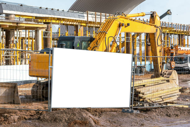 istock yellow excavator working on construction site mock-up 1197086177