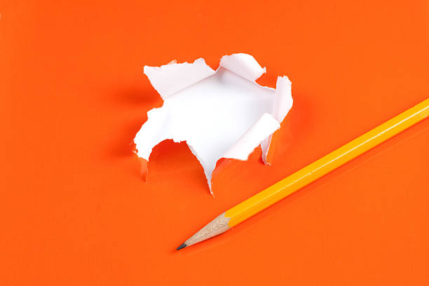 istock Torn orange paper hole. Tearing Inside white 119709311