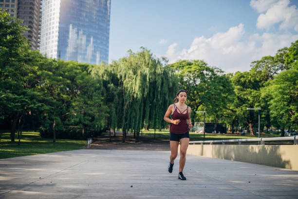 istock Beautiful young woman jogging in park. 1197094507