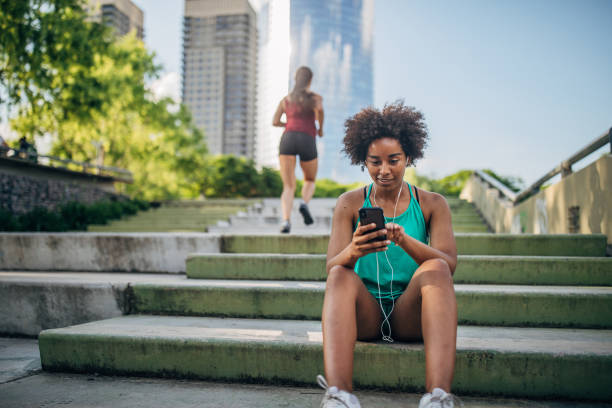 istock Beautiful young women resting after running 1197094820