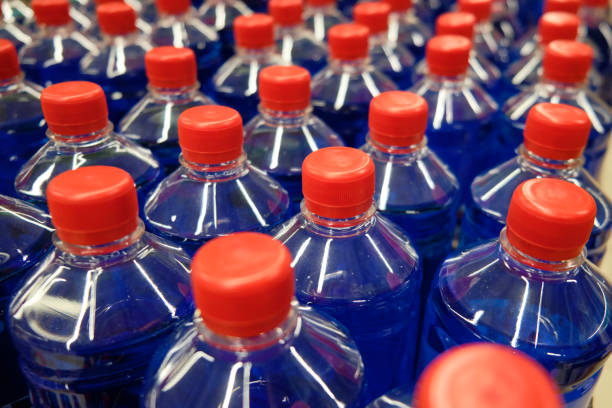 istock Dark blue fluid in the plastic bottles with red caps 1197096503