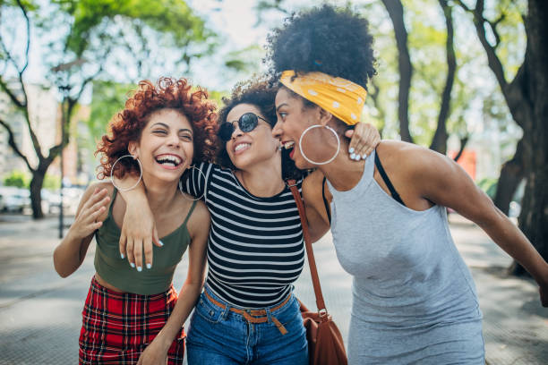 istock Three happy young women walking outdoors 1197096768