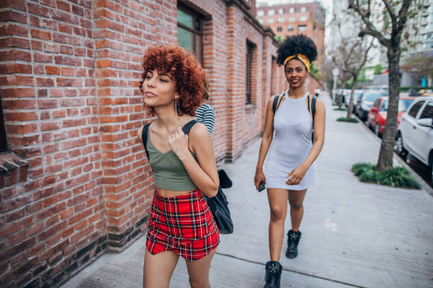 istock Three happy young women walking outdoors 1197096827