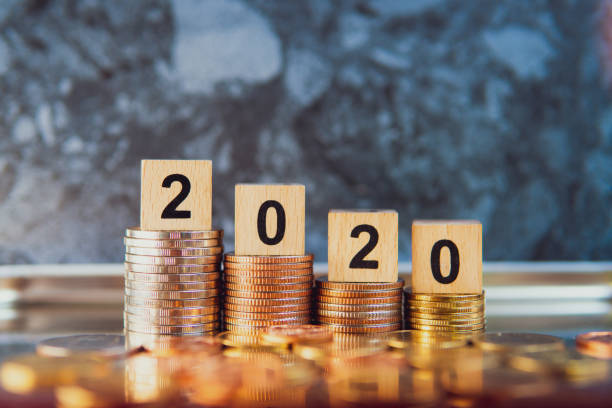 istock Wooden block year 2020 on stack coins 1197099753