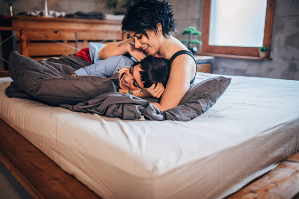 istock Lesbian couple cuddling in bed 1197100405