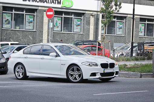 Ukraine, Kiev; March 5, 2014; White BMW (F10) in motion