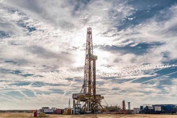 istock Oil drilling rig at sunset 1197105654