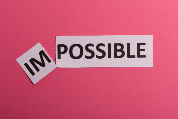 istock Impossible text cut out. Possible concept. Success. Pink background. Copy space. Vertical orientation. View from above. Minimal simple style. 1197105769