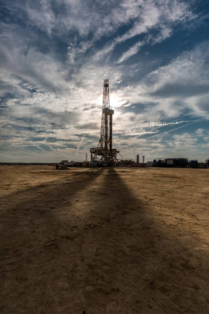 istock Oil drilling rig at sunset 1197105778