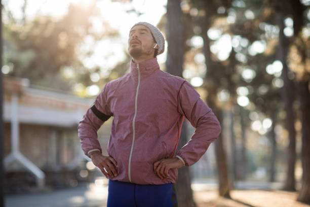 Man in sports clothes stretching and preparing to run