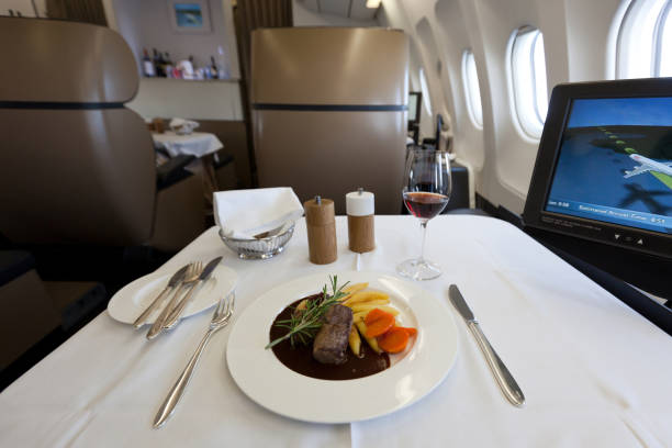 First Class main course and cabin view Delicious first class main course and cabin view. airplane food stock pictures, royalty-free photos & images