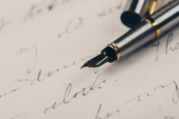 istock Fountain pen on an ancient handwritten letter. Old story. Retro style. 1197110810