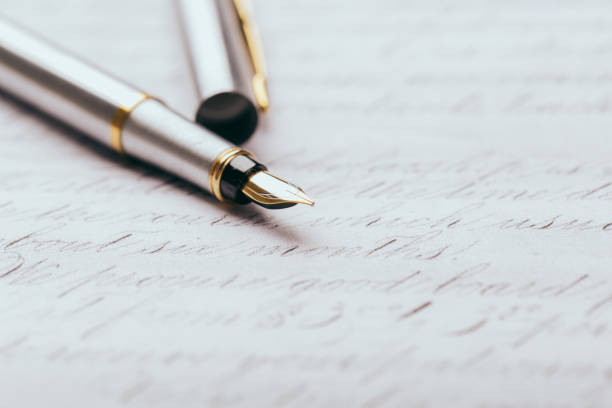 istock Fountain pen on an ancient handwritten letter. Old story. Retro style. 1197110835