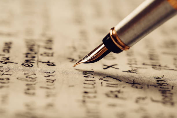 istock Fountain pen on an ancient handwritten letter. Old story. Retro style. 1197110840