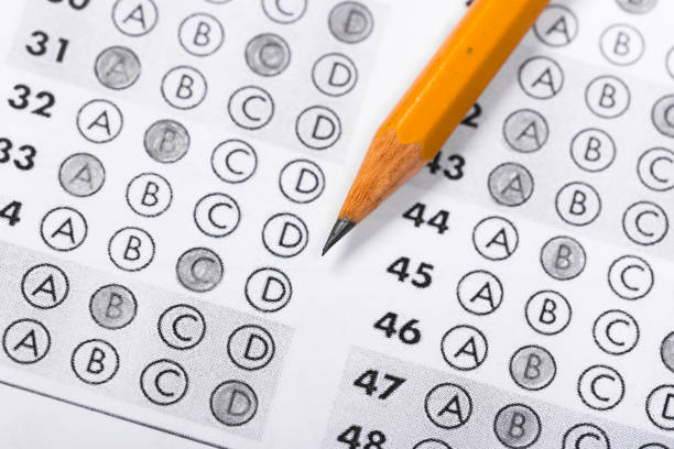 istock testing in exercise and exam paper. computer sheet with pencil in school test room, education concept 1197110981
