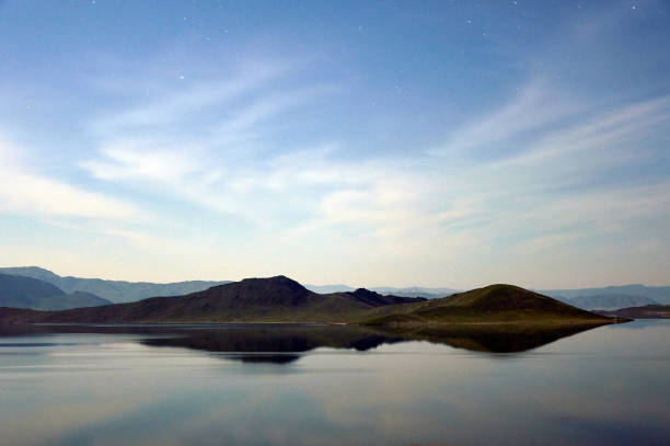 istock Hills and mountains reflected in a lake at twilight. 1197111249