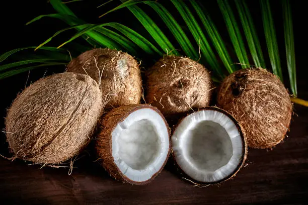 Photo of Low key of coconuts on wooden rustic table