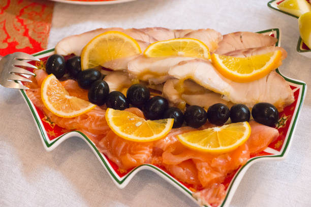 Stellate sturgeon and salmon on a Christmas plate in the form of a Christmas tree