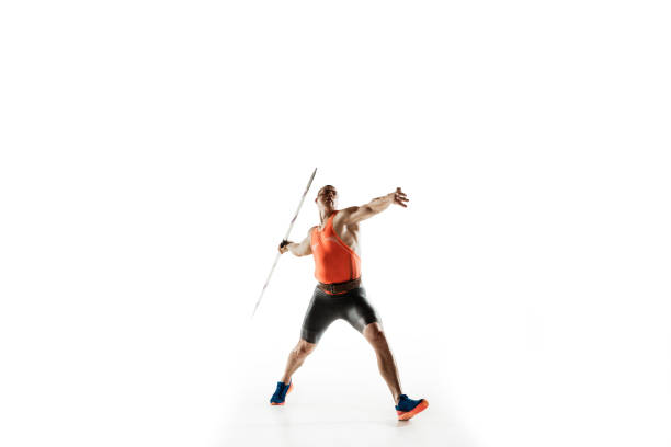 männliche athlet üben im werfen speer isoliert auf weißem studio hintergrund - javelin stock-fotos und bilder