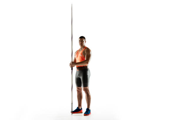 istock Male athlete practicing in throwing javelin isolated on white studio background 1197113194