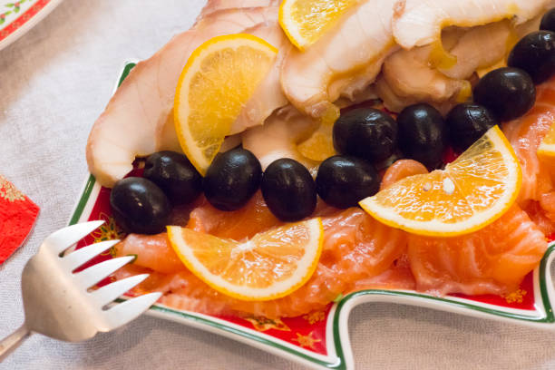 Stellate sturgeon and salmon on a Christmas plate in the form of a Christmas tree