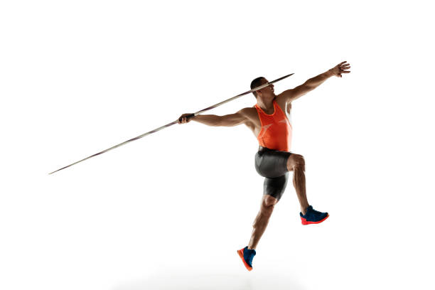 Male athlete practicing in throwing javelin isolated on white studio background Male athlete practicing in throwing javelin isolated on white studio background. Professional sportsman training in motion, action. Concept of healthy lifestyle, movement, activity. Copyspace. javelin stock pictures, royalty-free photos & images