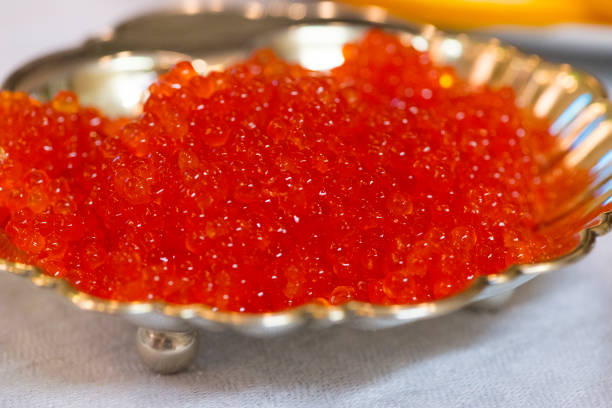 Close up shot of red caviar to be served with a wood spoon