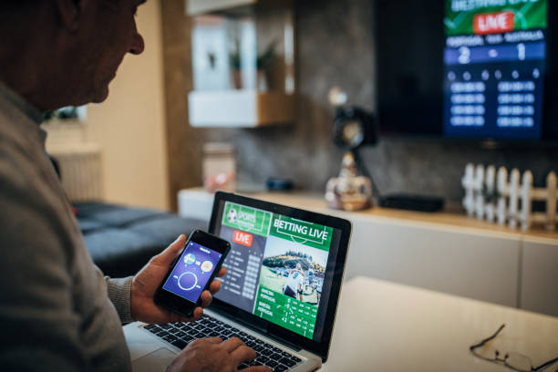 istock Watching football match on computer and betting 1197113695