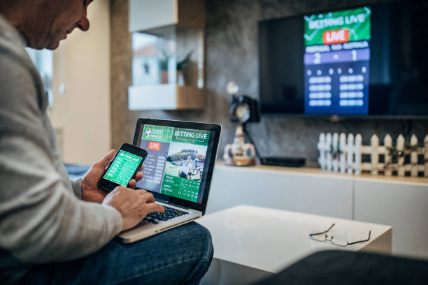 istock Watching football match on computer and betting 1197113749