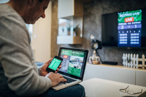 istock Watching football match on computer and betting 1197113794