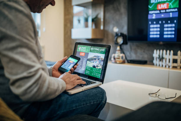 istock Watching football match on computer and betting 1197113909