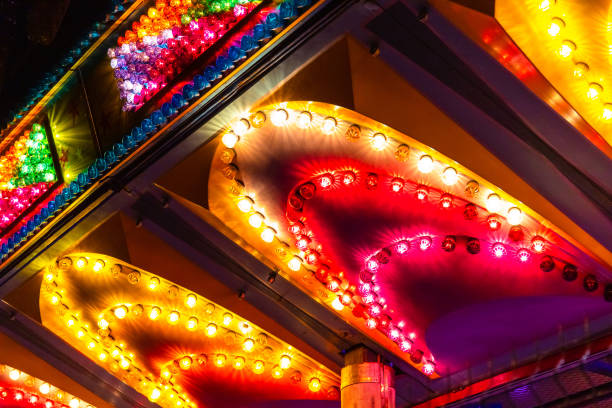 istock bright multi-colored lights of bulbs on an attraction 1197114569