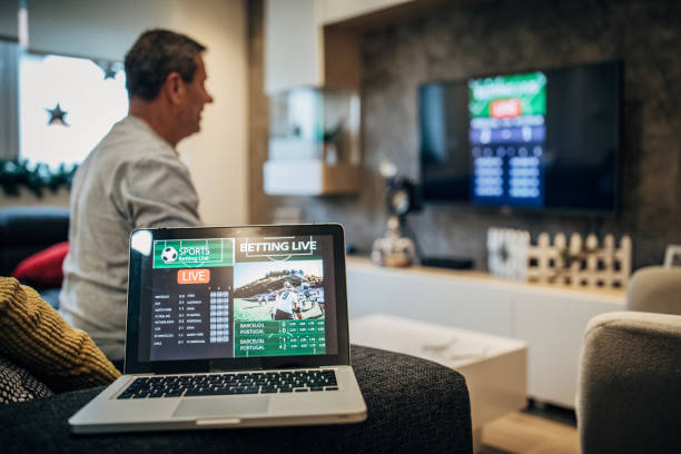 istock Watching football match on computer and betting 1197114631
