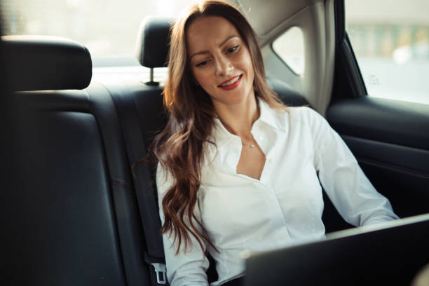 istock Businesswoman using laptop in a car 1197114903