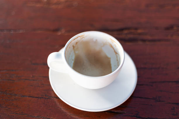 istock Empty coffee cup after drink on wood table In the coffee shop 1197114987