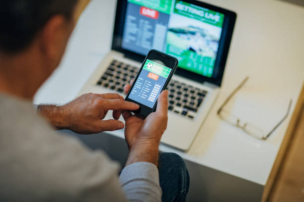 istock Mature man using mobile app for live betting 1197116834