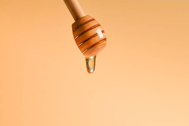 istock Dipper honey on orange background. Copy space. 1197116886