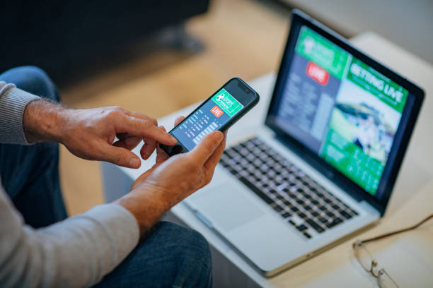 istock Mature man using mobile app for live betting 1197116909