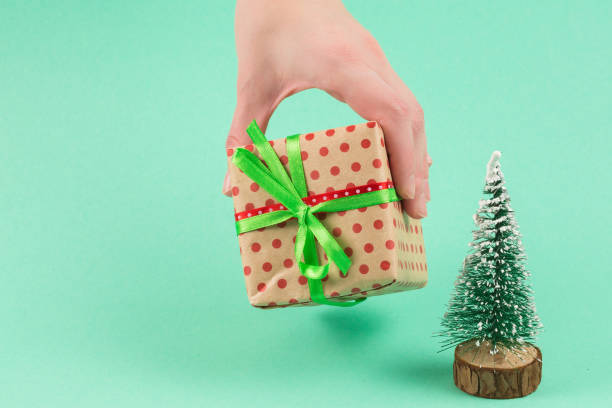 istock Present in woman hand on a green background. 1197116910