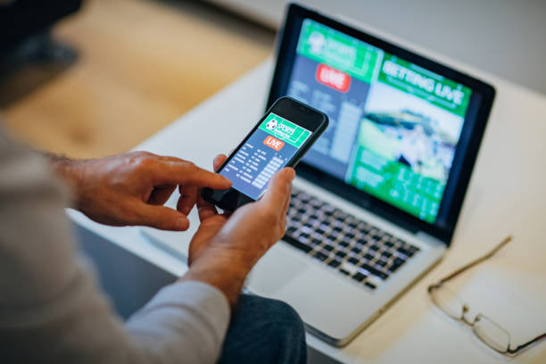 istock Mature man using mobile app for live betting 1197116965
